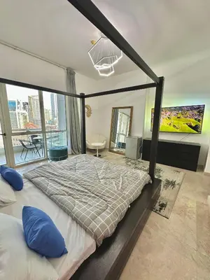 a bedroom with a large bed with a large window at Marina Haven with Jacuzzi in Dubai