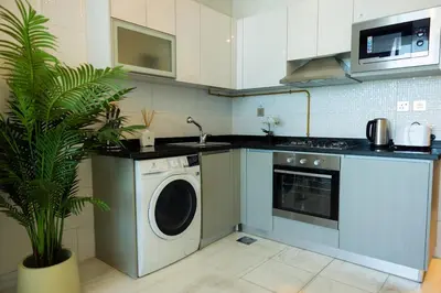 a kitchen with a washing machine and a dishwasher at Studio in downtown with Burj Khalifa and city view in Dubai