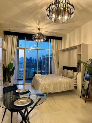 a bedroom with a bed and a chandelier at Studio in downtown with Burj Khalifa and city view in Dubai