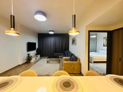 a living room with a table and a couch and a bedroom at Airvistas retreat at wasl one residence in Dubai