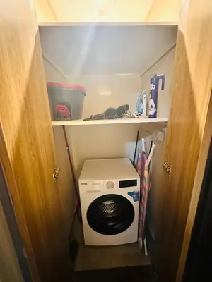 a small kitchen with a washing machine in a room at Airvistas retreat at wasl one residence in Dubai