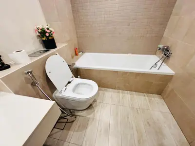 a bathroom with a toilet and a bath tub at Airvistas retreat at wasl one residence in Dubai