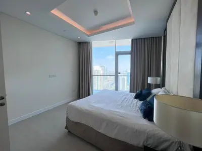 a bedroom with a large bed and a large window at The Burj Panarama in Dubai