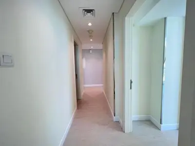 a hallway with white walls and a long corridor at The Burj Panarama in Dubai