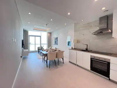 a kitchen with a table and a dining room at The Burj Panarama in Dubai