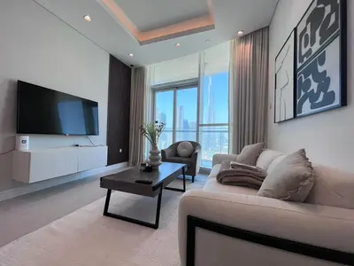 a living room with a couch and a tv at The Burj Panarama in Dubai