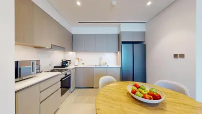 a kitchen with a wooden table with a bowl of fruit on it at Best 2 bedroom Direct Burj Khalifa Downtown View in Dubai