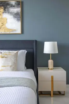 a bedroom with a bed and a lamp on a nightstand at Frank Porter - Samana Park Views in Dubai