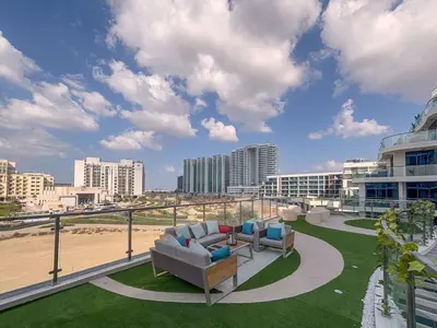 a patio with two couches and a view of the beach at Frank Porter - Samana Park Views in Dubai