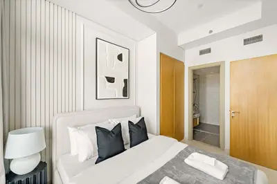 a bedroom with a white bed and a bathroom at Silkhaus Luxury 2BDR at Aykon City in Business Bay in Dubai