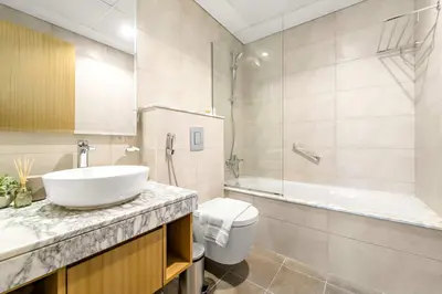 a bathroom with a sink and a tub and a toilet at Silkhaus Luxury 2BDR at Aykon City in Business Bay in Dubai
