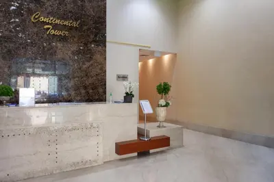 a lobby of a building with a counter and a mirror at Waves - Charming Apt With Balcony Steps From The Beach in Dubai
