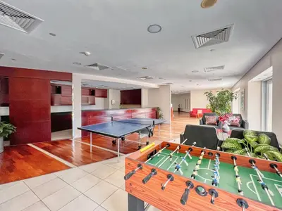 a living room with a ping pong table in it at FIRST CLASS 1BR Inviting Marina Views in Dubai