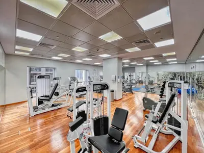 a gym with treadmills and elliptical machines at FIRST CLASS 1BR Inviting Marina Views in Dubai