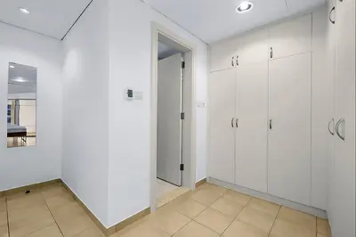 an empty room with white cabinets and a hallway at FIRST CLASS 1BR Inviting Marina Views in Dubai
