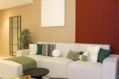 a living room with a white couch with pillows at Elegant 1BR in Heart of Dubai, Walk to Top Malls in Dubai