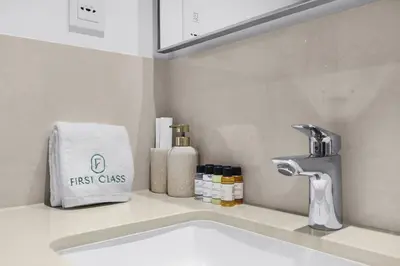 a bathroom with a sink and a faucet at Elegant 1BR in Heart of Dubai, Walk to Top Malls in Dubai