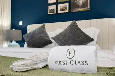 a bed with a first class pillow on it at Elegant 1BR in Heart of Dubai, Walk to Top Malls in Dubai