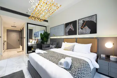 a bedroom with a large bed and a living room at Luxury Studio Near Dubai Mall few mints walk in Dubai