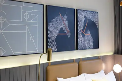 a hotel room with three paintings on the wall at Luxury Studio Near Dubai Mall few mints walk in Dubai