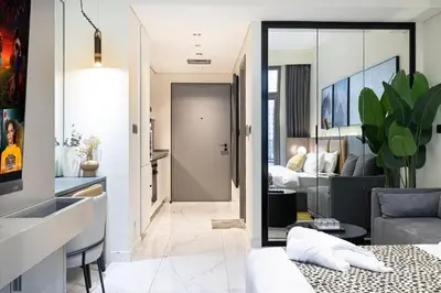 a living room with a couch and a bedroom at Luxury Studio Near Dubai Mall few mints walk in Dubai