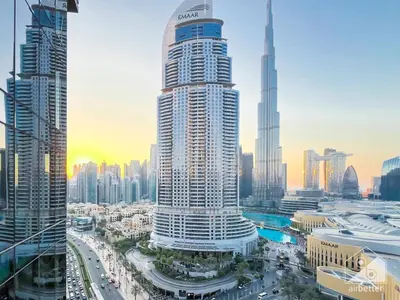a large building in a city with many tall buildings at Elegant 2B at Boulevard Point Burj & Fountain View in Dubai
