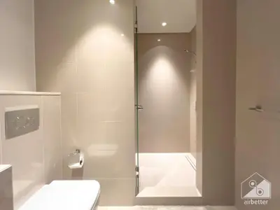 a bathroom with a shower stall and a toilet at Elegant 2B at Boulevard Point Burj & Fountain View in Dubai
