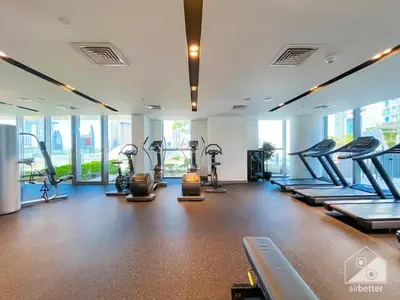 a gym with treadmills and machines in a room at Elegant 2B at Boulevard Point Burj & Fountain View in Dubai