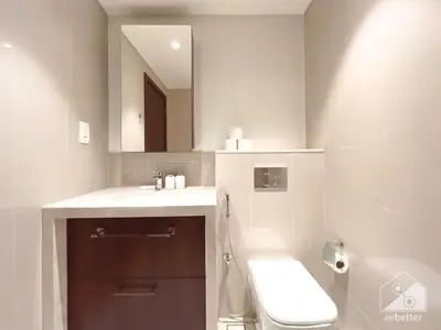 a bathroom with a sink and a toilet and a mirror at Elegant 2B at Boulevard Point Burj & Fountain View in Dubai