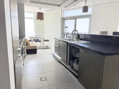 a kitchen with a sink and a dishwasher at The Lofts West Downtown - 2 Minutes Walk to Burj Khalifa-Dubai Mall 1BDR in Dubai