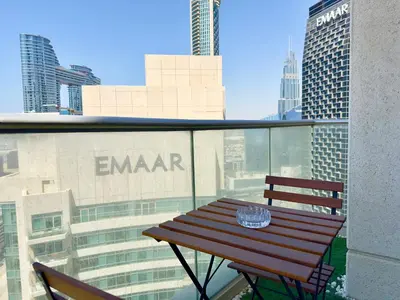 a wooden table sitting on top of a balcony at The Lofts West Downtown - 2 Minutes Walk to Burj Khalifa-Dubai Mall 1BDR in Dubai