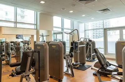 a gym with treadmills and exercise bikes in it at The Lofts West Downtown - 2 Minutes Walk to Burj Khalifa-Dubai Mall 1BDR in Dubai
