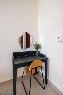 a black desk with a chair and a mirror at Central Park Tower DIFC - 10 Minutes Walk to Metro - Spacious 1BDR in Dubai