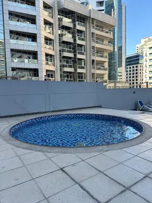 a circular pool of blue water in a city at Marina Diamond 2 - Very Close to Metro - Cozy in Dubai