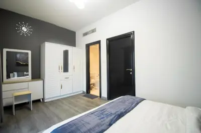 a bedroom with a bed and a black door at Marina Diamond 2 - Very Close to Metro - Cozy in Dubai