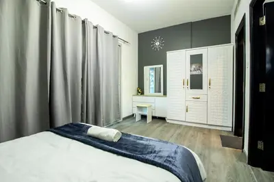 a bedroom with a bed and a desk in it at Marina Diamond 2 - Very Close to Metro - Cozy in Dubai