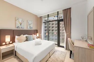 a bedroom with a large bed and a large window at Luxury 1BR in Seven Palm with Beach Access in Dubai