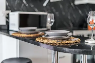 a table with plates and glasses of wine at GuestReady - Elegant studio in JLT in Dubai