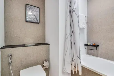 a bathroom with a toilet and a bath tub at GuestReady - Elegant studio in JLT in Dubai