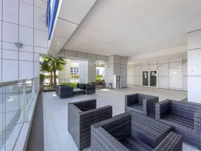 a lobby with chairs and tables in a building at SUNRISE HOMES - A Modern Studio near JBR Beach in Dubai
