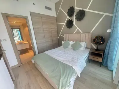 a bedroom with a large bed with green pillows at Beautiful 1 bed apartment Marina I Sleeps 4 in Dubai