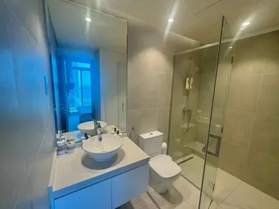 a bathroom with a sink and a toilet and a shower at Beautiful 1 bed apartment Marina I Sleeps 4 in Dubai