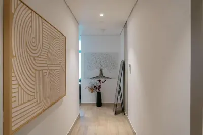 a hallway with a large painting on the wall at Beautiful 1 bed apartment Marina I Sleeps 4 in Dubai