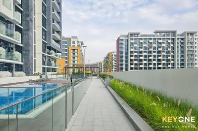 a walkway in the middle of a city with buildings at Exquisite Living in Riviera One Bedroom in Dubai