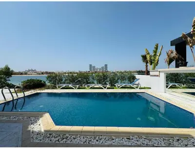 a swimming pool with a view of the water at Palm villas in Dubai