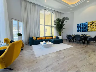 a living room with a couch and a table at Palm villas in Dubai