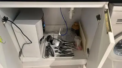 a white cabinet with a bunch of utensils in it at Capital bay in Dubai