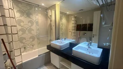 a bathroom with two sinks and a shower at Capital bay in Dubai