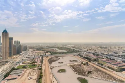 an aerial view of a city with buildings and roads at 2BR Canal View Flat with Pool, Gym, 10 min Drive to Dubai Mall in Dubai