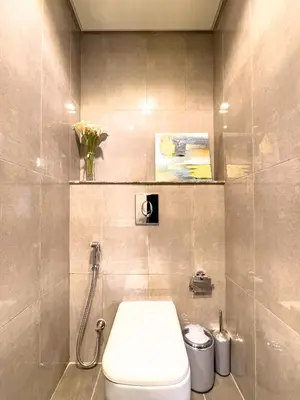 a bathroom with a white toilet and a shower at Stylish 1BR Business Bay - Near Metro - Balcony with City Views in Dubai